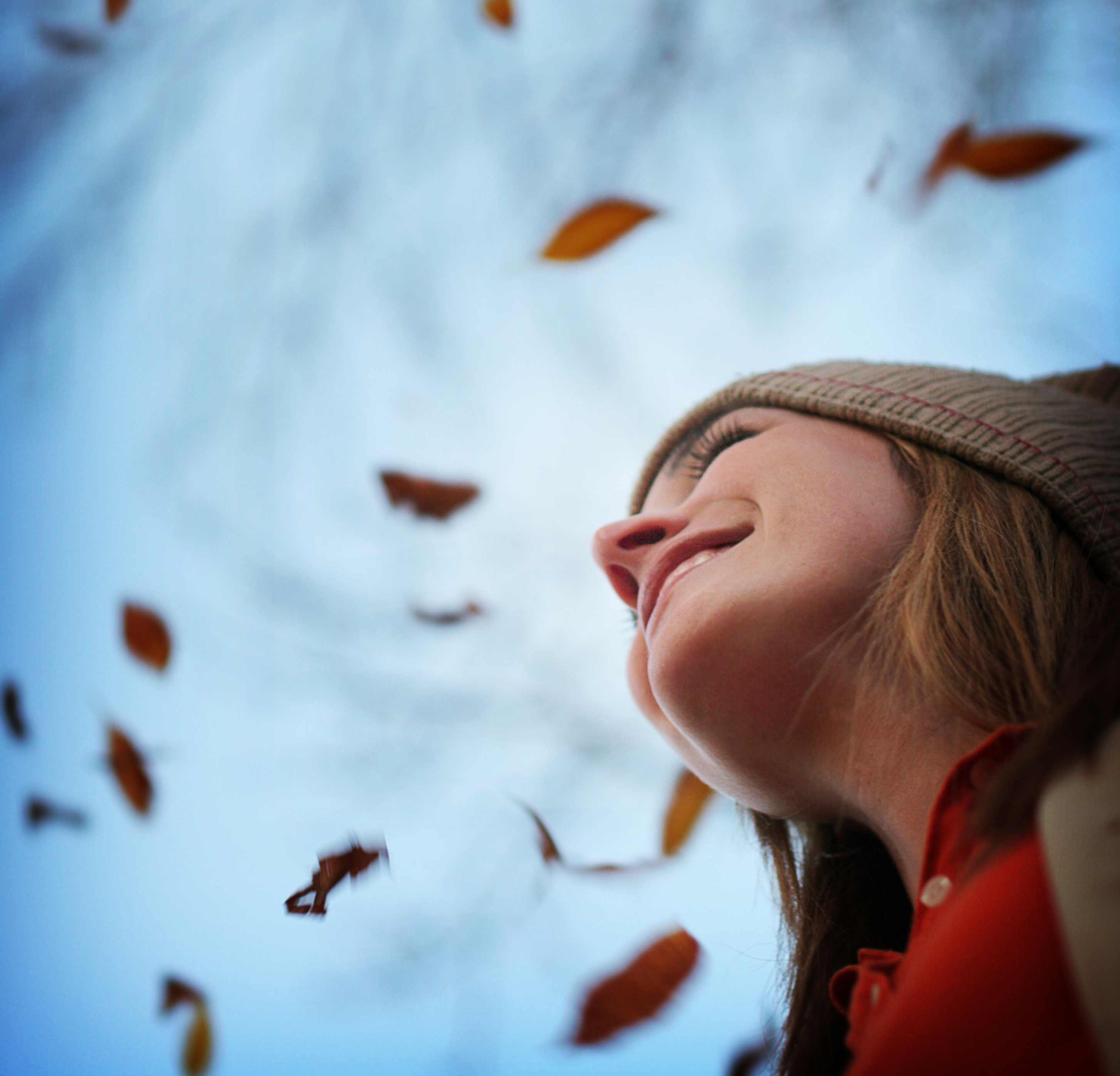 Woman surrounded by falling leaves