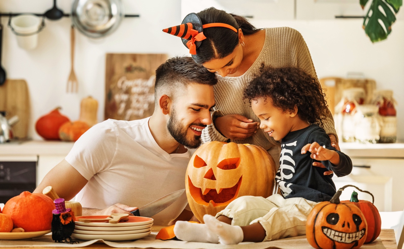 family carving pumpkin